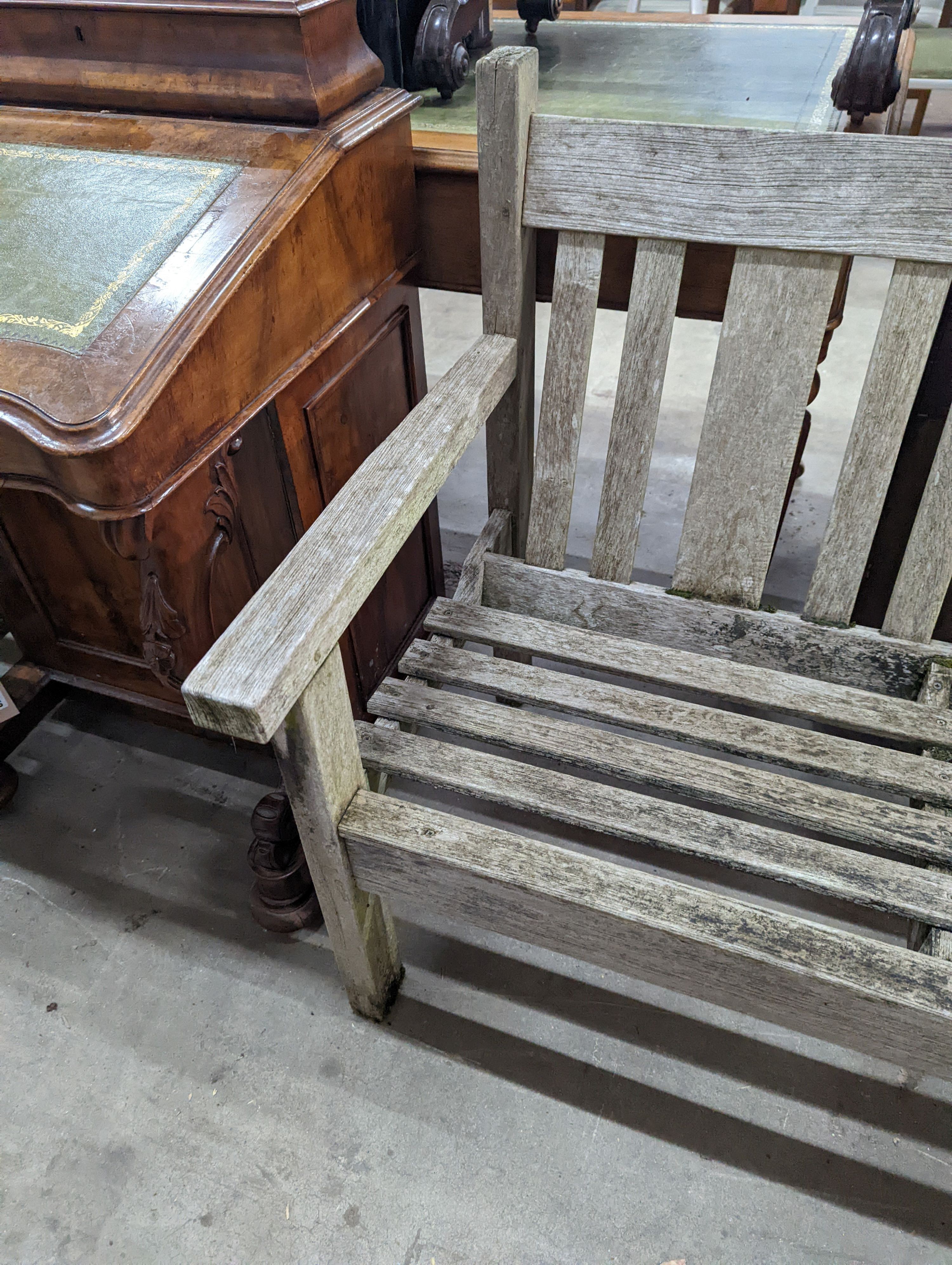 A weathered teak garden bench, length 158cm, depth 62cm, height 84cm